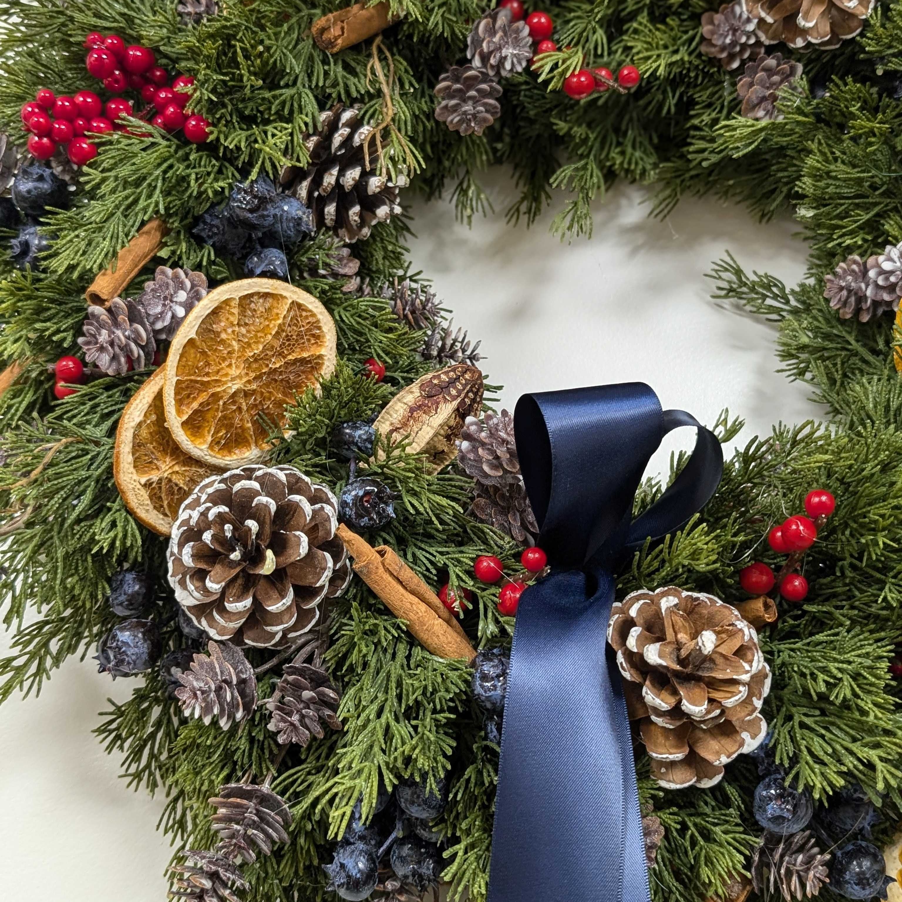 Spiced Citrus & Cedar Wreath - 20" Artificial Cedar Wreath - Blue & Red Berries, Dried Oranges, Navy Bow