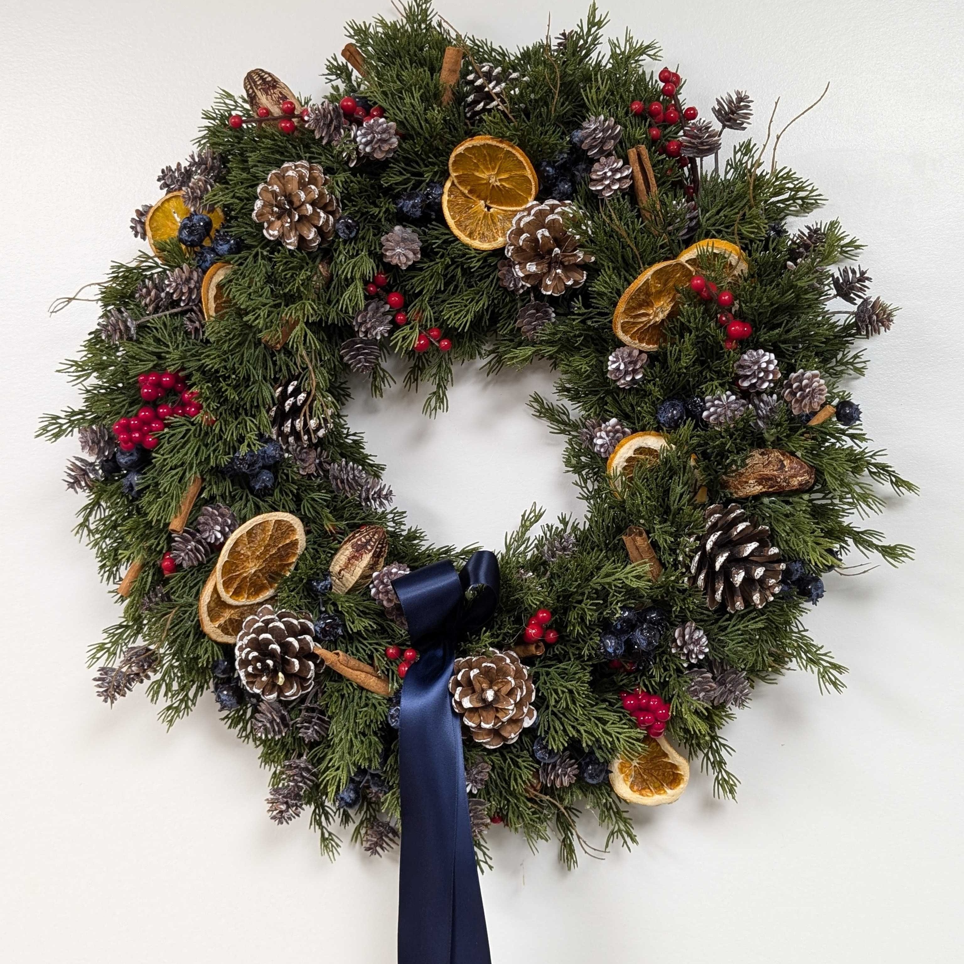 Spiced Citrus & Cedar Wreath - 20" Artificial Cedar Wreath - Blue & Red Berries, Dried Oranges, Navy Bow